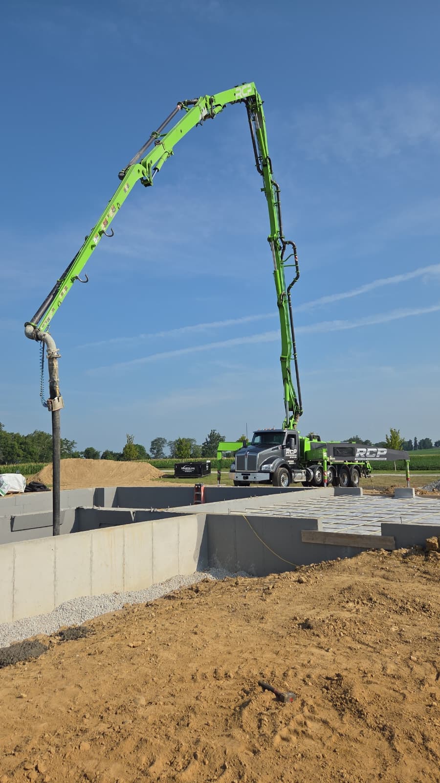 Green Rapid-Crete 38-meter boom pump at a jobsite